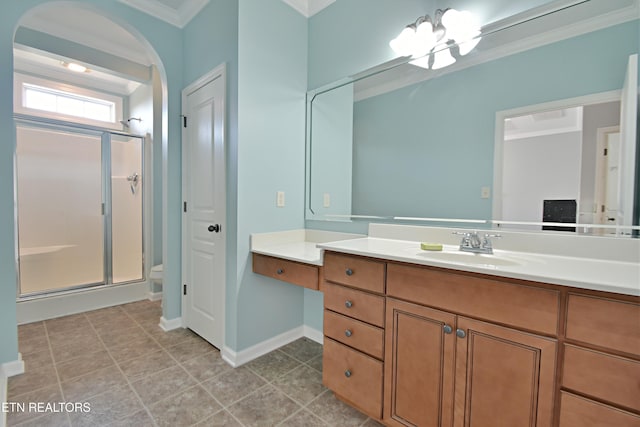 bathroom with vanity, ornamental molding, toilet, and a shower stall