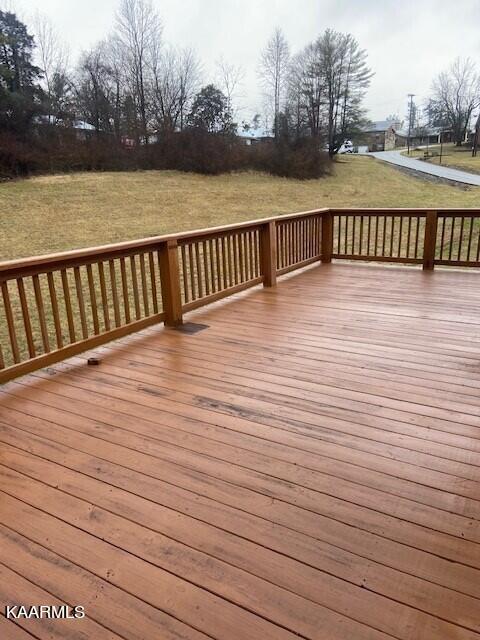 wooden terrace with a lawn