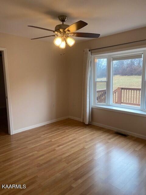 spare room with light hardwood / wood-style flooring and ceiling fan