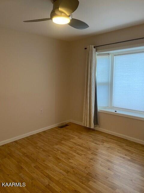 empty room featuring ceiling fan and light wood-type flooring