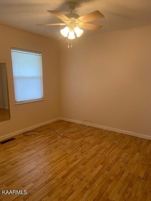 spare room featuring ceiling fan and wood-type flooring