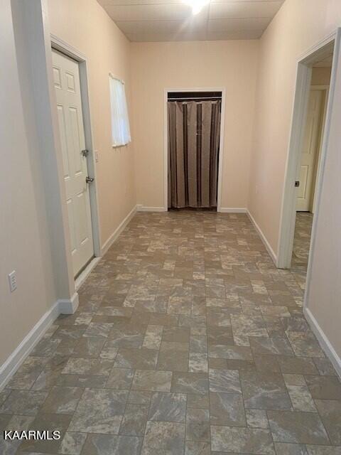 corridor with dark tile floors