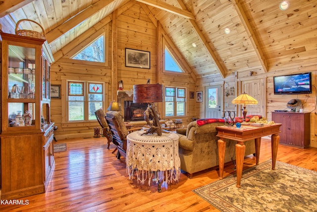 living room with wooden walls, light hardwood / wood-style flooring, beamed ceiling, and wood ceiling