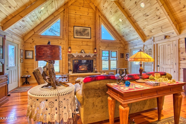 living room with beam ceiling, high vaulted ceiling, wooden ceiling, and light hardwood / wood-style floors