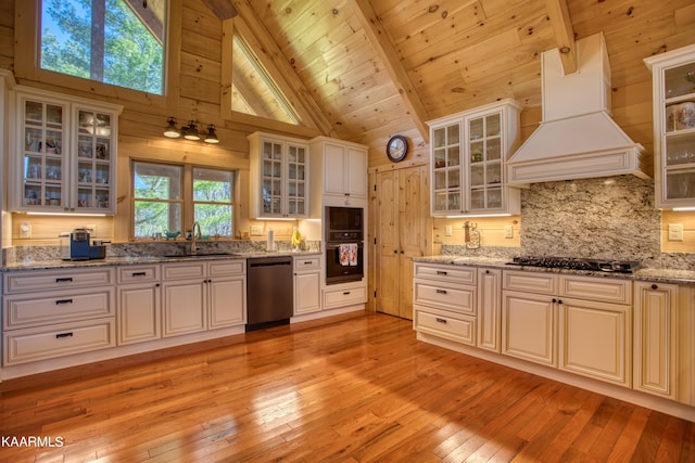 kitchen featuring beam ceiling, sink, high vaulted ceiling, black appliances, and custom range hood