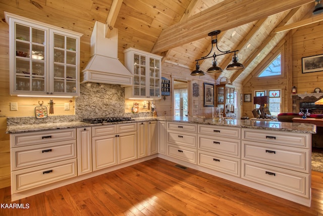 kitchen with beam ceiling, wood ceiling, premium range hood, and black gas cooktop