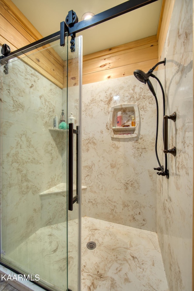 bathroom featuring a shower with door