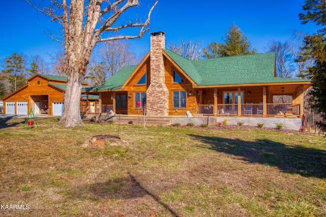 view of front facade with a porch, a garage, an outdoor structure, and a front lawn