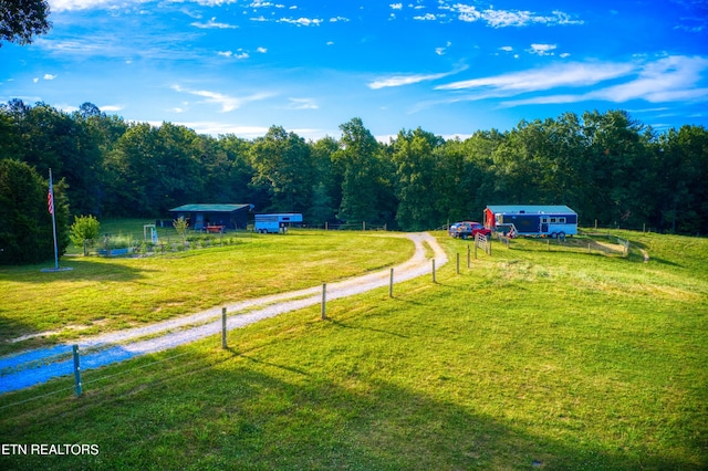 view of home's community featuring a yard and a rural view