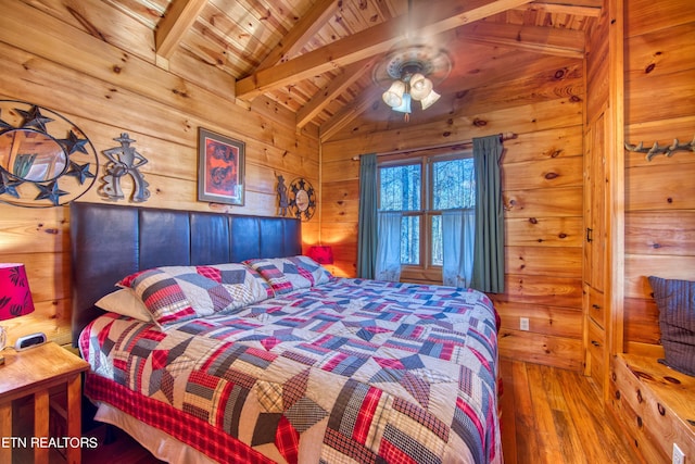 bedroom featuring hardwood / wood-style flooring, vaulted ceiling with beams, wooden ceiling, and wooden walls