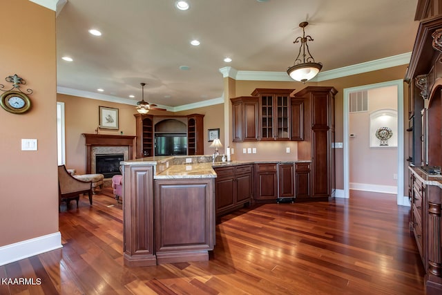 kitchen featuring decorative light fixtures, ceiling fan, crown molding, and dark hardwood / wood-style floors