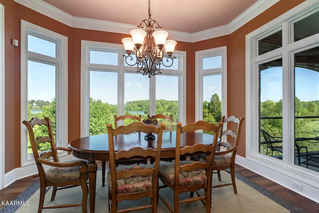 dining area featuring ornamental molding, dark hardwood / wood-style floors, and an inviting chandelier