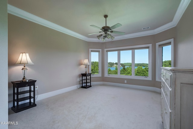 living area featuring ceiling fan, crown molding, and light carpet