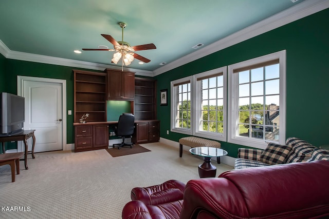 living room featuring ceiling fan, crown molding, and light carpet