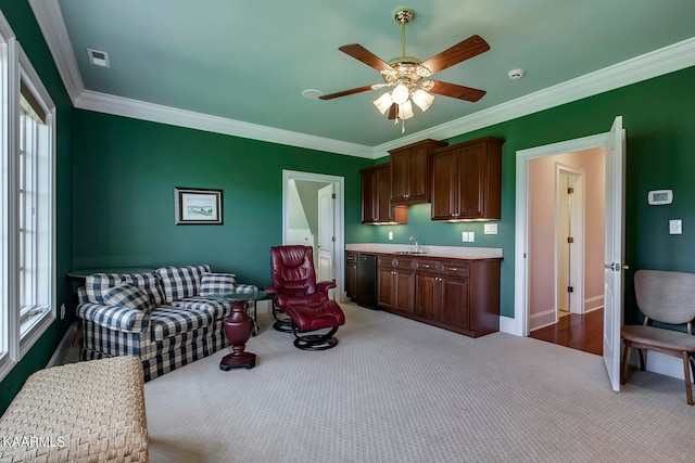 living room with a healthy amount of sunlight, hardwood / wood-style floors, ceiling fan, and crown molding