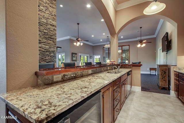 kitchen with ceiling fan, hanging light fixtures, light tile flooring, and sink