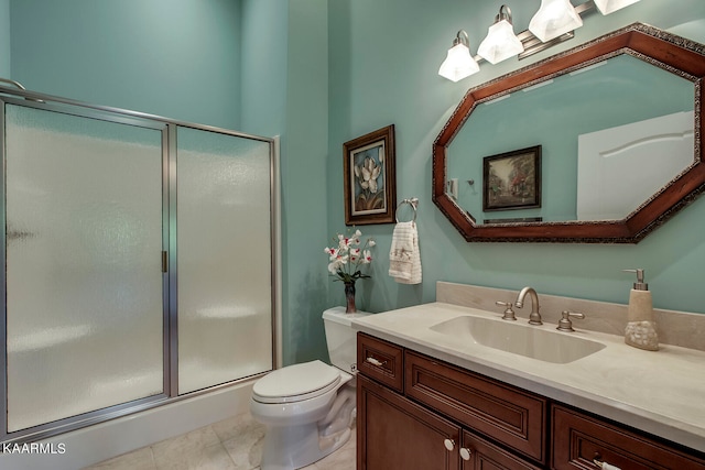 bathroom featuring tile floors, toilet, vanity, and an enclosed shower