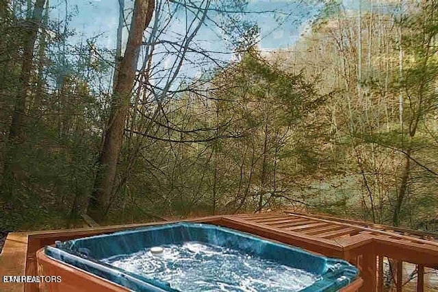 view of pool with a hot tub