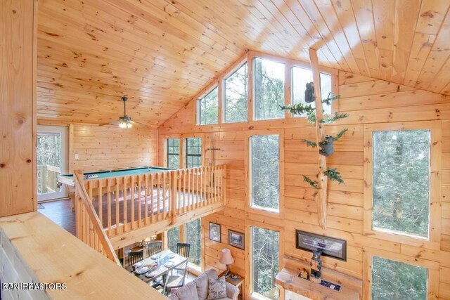 interior space featuring wooden walls, lofted ceiling, wooden ceiling, and hardwood / wood-style floors