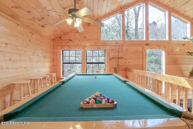 recreation room with wood walls, pool table, ceiling fan, and vaulted ceiling