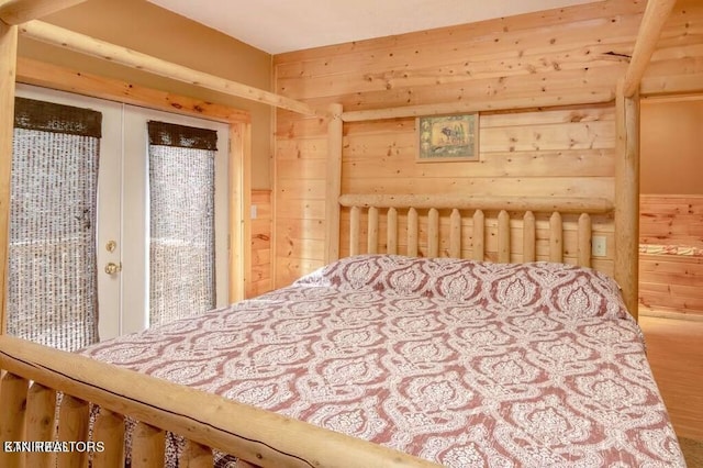 bedroom featuring wood-type flooring and wood walls