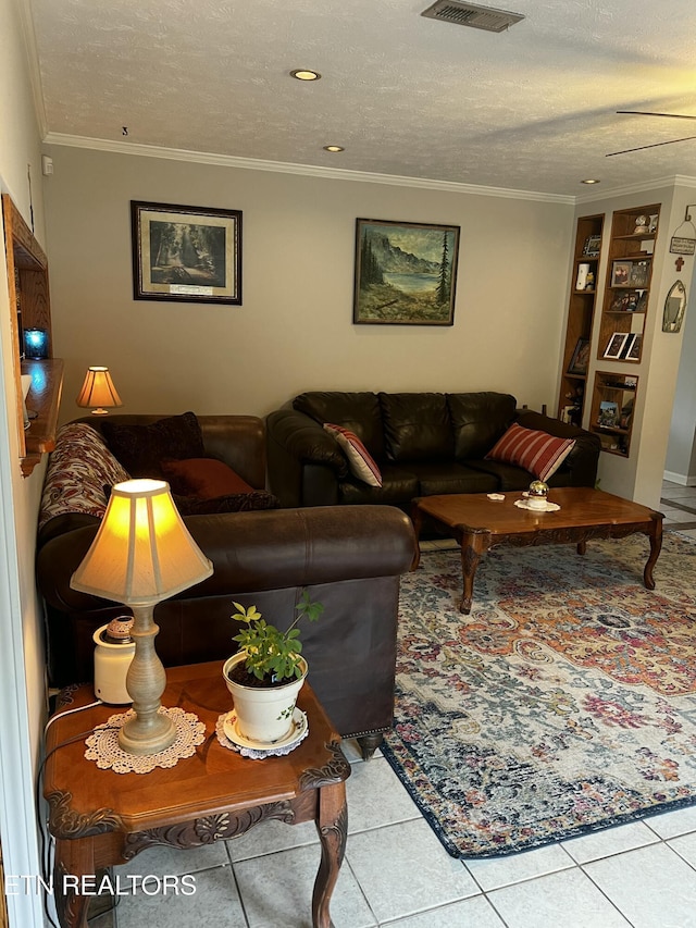 living area featuring crown molding, tile patterned floors, and a textured ceiling