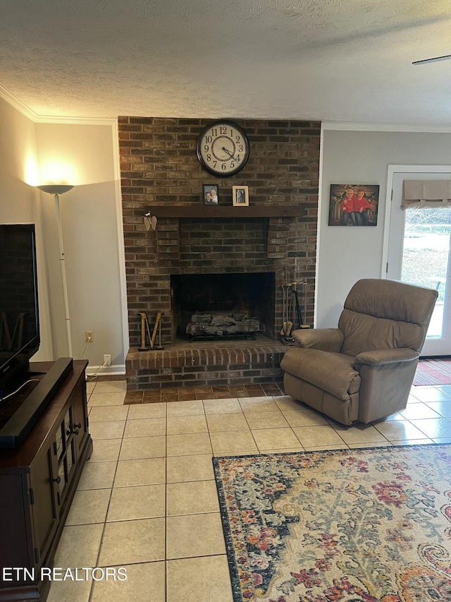 living area with tile patterned floors, ornamental molding, a textured ceiling, baseboards, and a brick fireplace