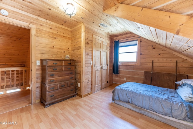 bedroom featuring lofted ceiling, wooden ceiling, and light hardwood / wood-style flooring