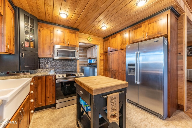 kitchen featuring stainless steel appliances, light tile floors, wood ceiling, wooden counters, and backsplash