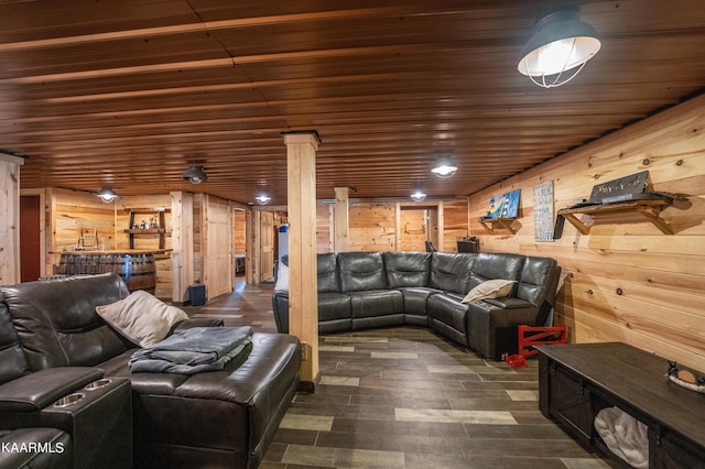 living room featuring wood ceiling, wooden walls, and ornate columns