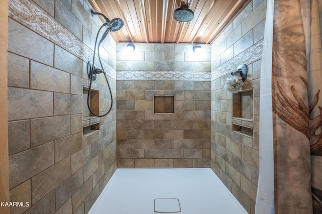 bathroom with wooden ceiling and a tile shower