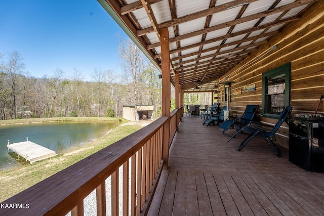 deck with an outdoor structure and a water view