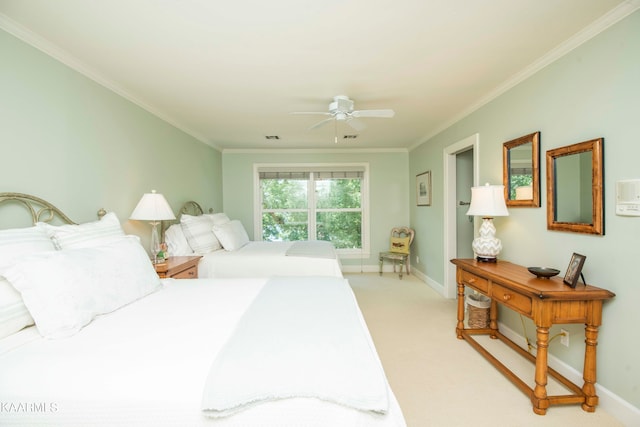 carpeted bedroom featuring ceiling fan and ornamental molding