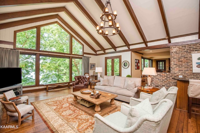 living room featuring high vaulted ceiling, a notable chandelier, beamed ceiling, and hardwood / wood-style floors