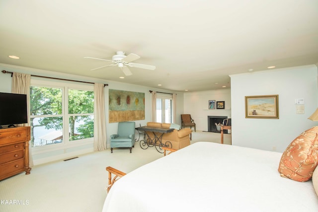 carpeted bedroom with ceiling fan and ornamental molding