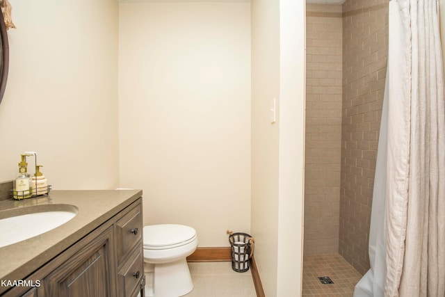 bathroom featuring toilet, vanity, tile patterned flooring, and walk in shower