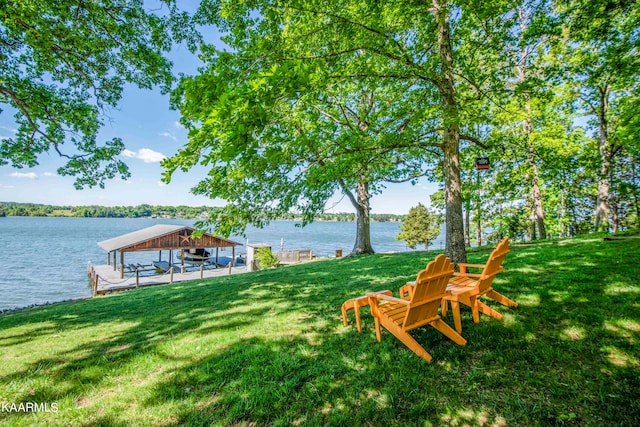 view of yard with a water view and a dock