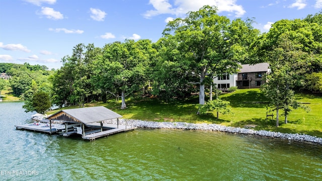 dock area featuring a lawn and a water view