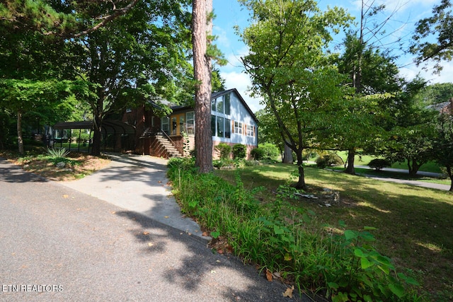 view of side of property with a yard and a carport