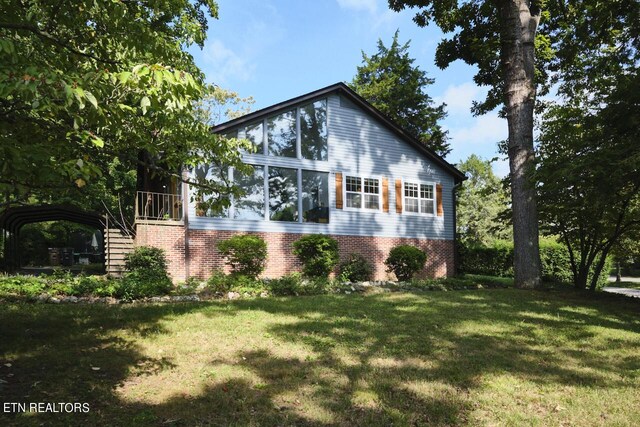 view of home's exterior with a lawn