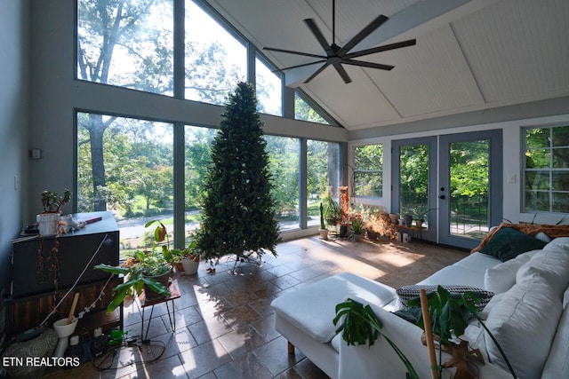 sunroom with ceiling fan, vaulted ceiling, and french doors