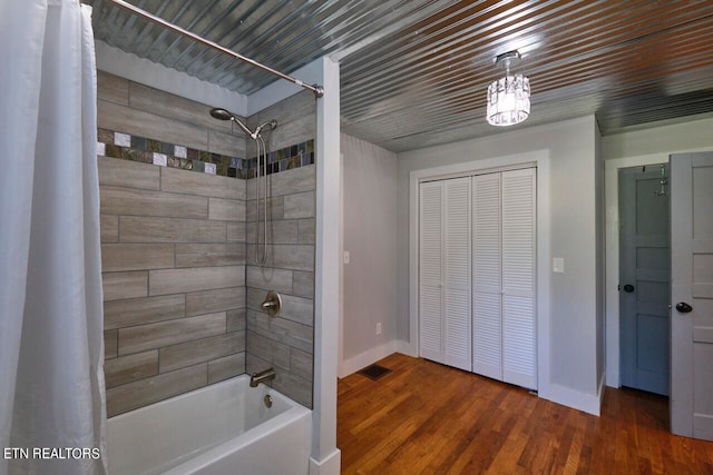 bathroom featuring hardwood / wood-style floors and shower / tub combo with curtain