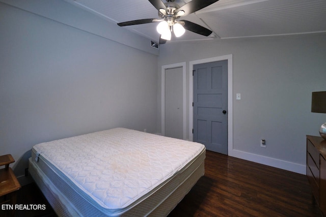 bedroom with ceiling fan, dark hardwood / wood-style flooring, and vaulted ceiling