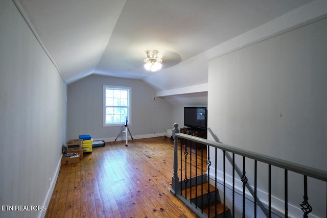 bonus room with hardwood / wood-style flooring and vaulted ceiling