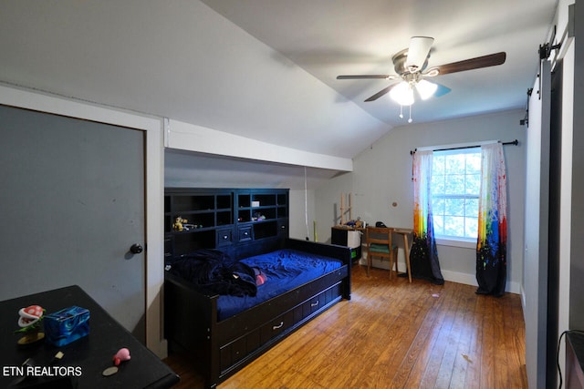 bedroom featuring ceiling fan, hardwood / wood-style flooring, and vaulted ceiling