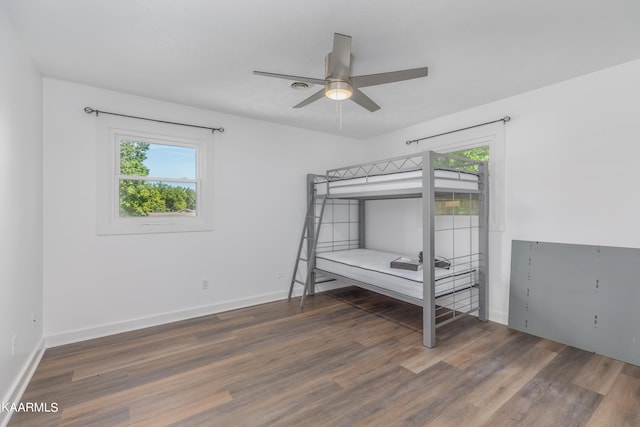 unfurnished bedroom featuring dark hardwood / wood-style flooring and ceiling fan