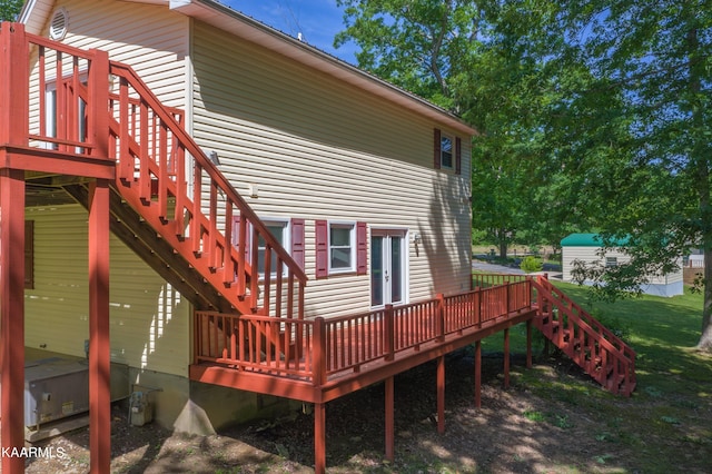 back of property featuring a wooden deck