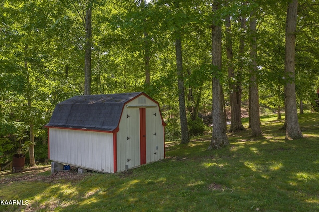 view of outdoor structure featuring a lawn