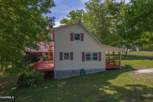 view of home's exterior with a lawn and a wooden deck