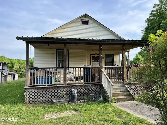 bungalow-style house featuring a porch and a front lawn